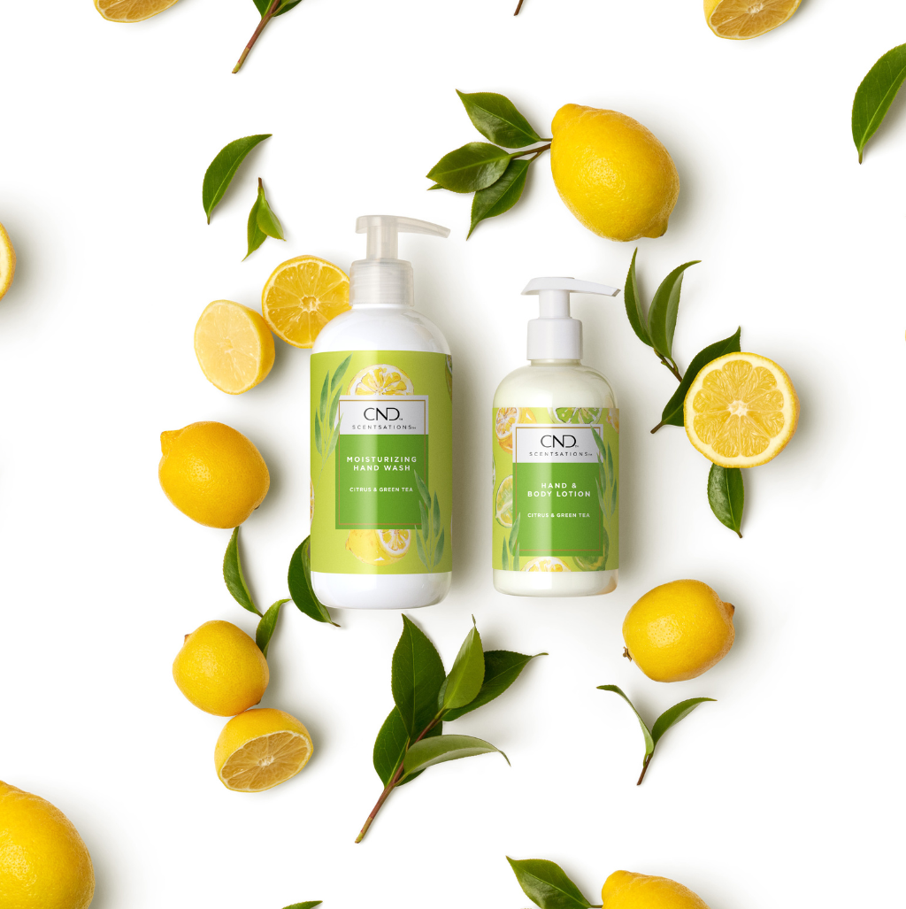 Two bottle of Citrus and Green Tea body lotion on lemons and leaves.