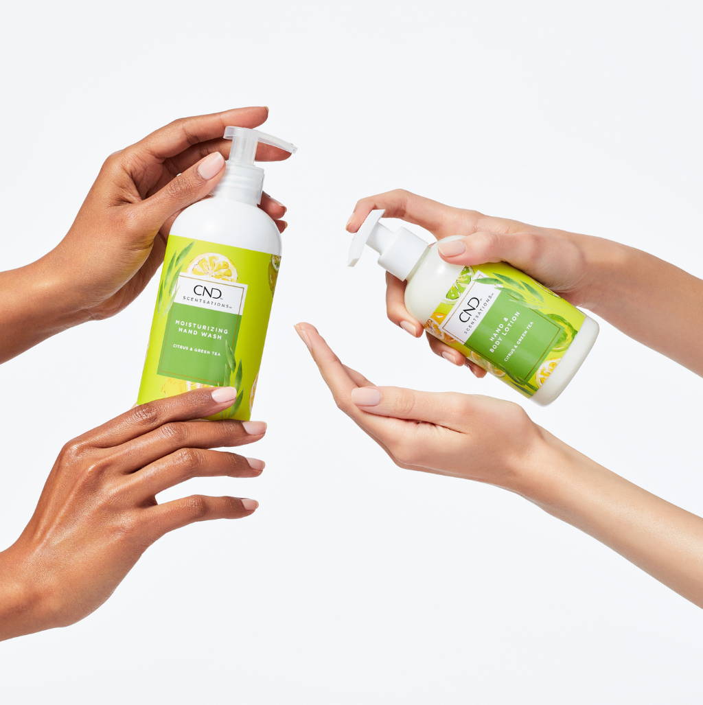 Two sets of hand, each holding a pump bottle of hand wash and body lotion in pump bottles, green labels.